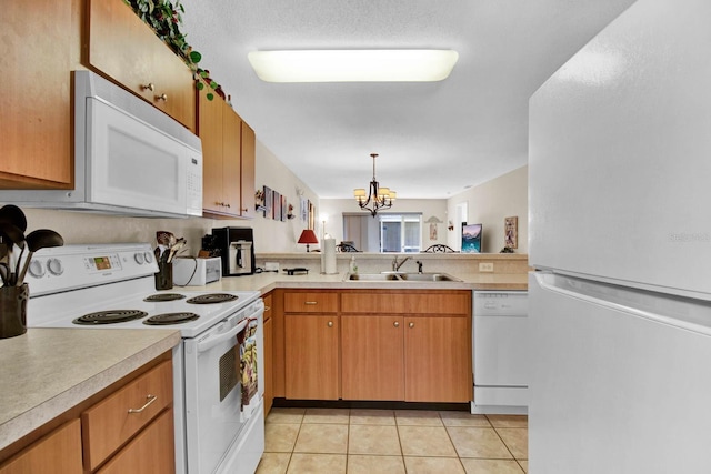 2216 Mystic Ring Loop, Poinciana, FL 34759 - kitchen featuring white appliances, light countertops, a chandelier, light tile patterned flooring, and pendant lighting