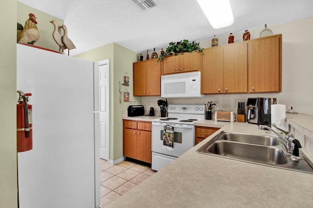 2216 Mystic Ring Loop, Poinciana, FL 34759 - kitchen featuring white appliances, light tile patterned floors, and light countertops
