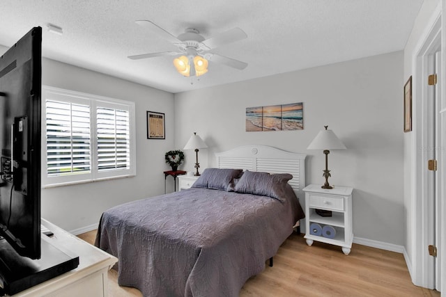 2216 Mystic Ring Loop, Poinciana, FL 34759 - bedroom featuring light wood-style flooring, ceiling fan, and a textured ceiling
