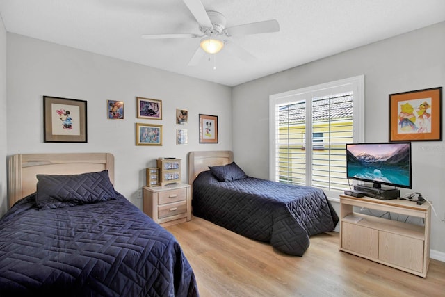 2216 Mystic Ring Loop, Poinciana, FL 34759 - bedroom featuring light wood-style flooring and a ceiling fan