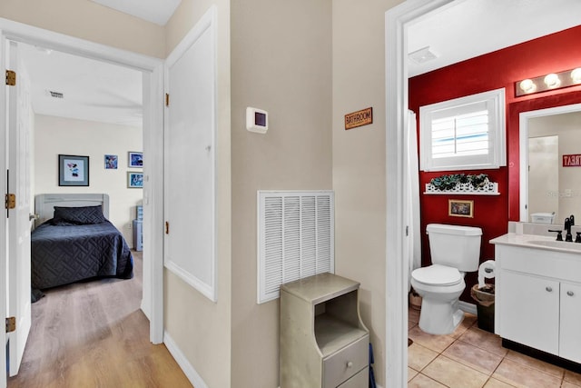2216 Mystic Ring Loop, Poinciana, FL 34759 - bathroom featuring vanity, ensuite bathroom, and wood finished floors