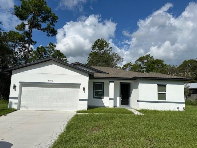 single story home featuring a garage and a front yard