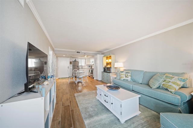 living room featuring light hardwood / wood-style flooring and ornamental molding