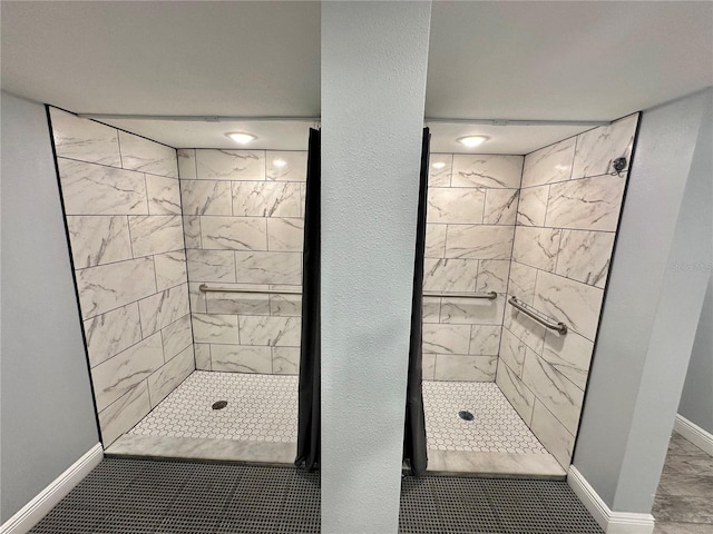 bathroom with tile patterned floors and tiled shower