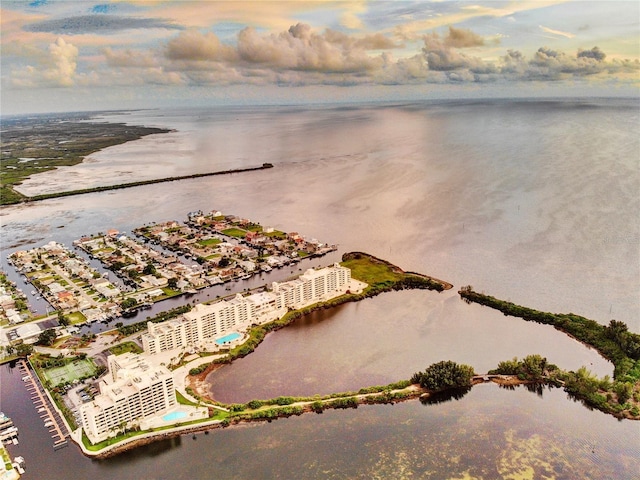 aerial view at dusk featuring a water view