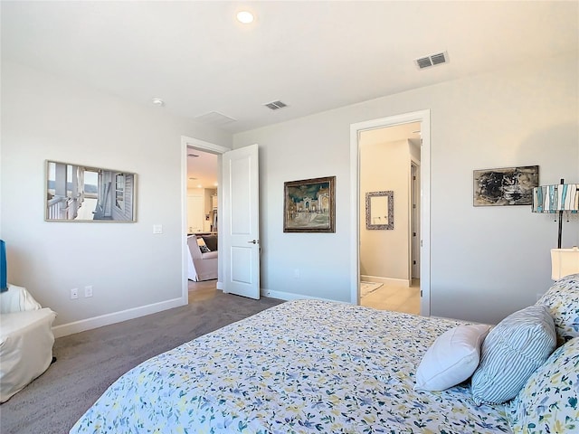 carpeted bedroom featuring ensuite bath