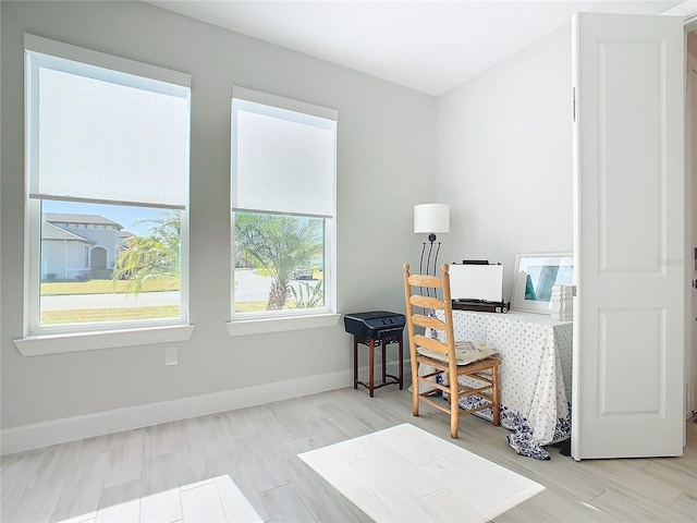 home office with light hardwood / wood-style flooring