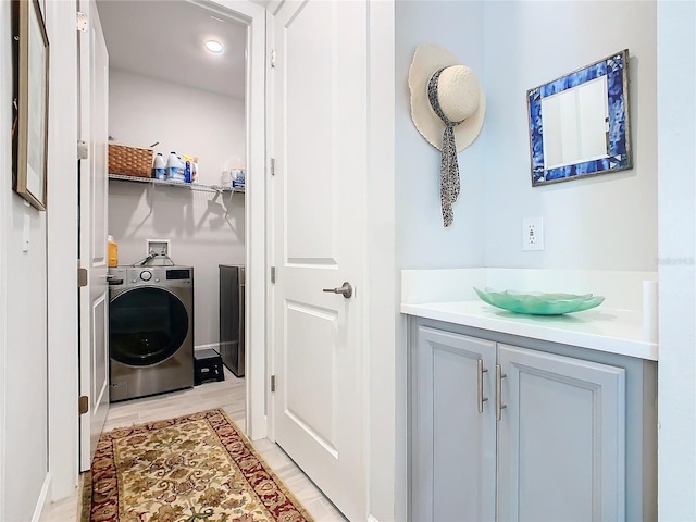 washroom featuring washer / dryer and light wood-type flooring