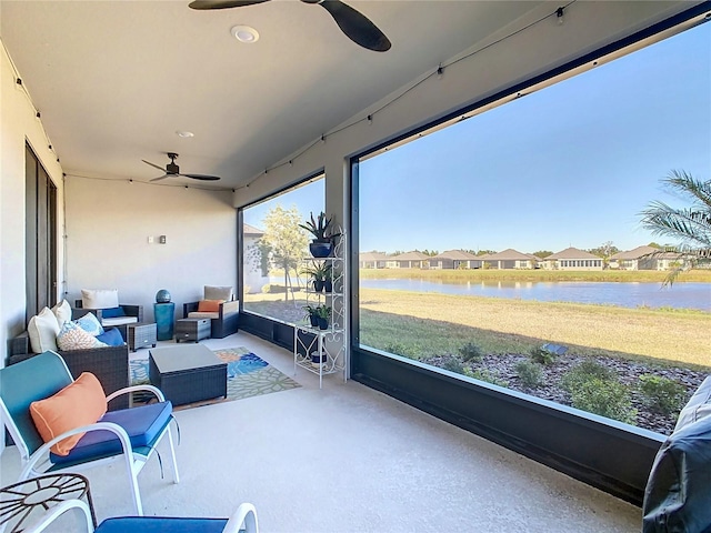 sunroom featuring a water view