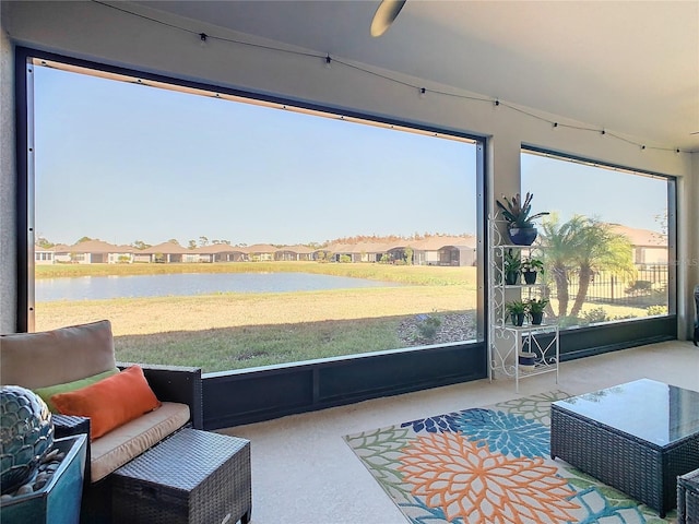 sunroom / solarium with a wealth of natural light and a water view