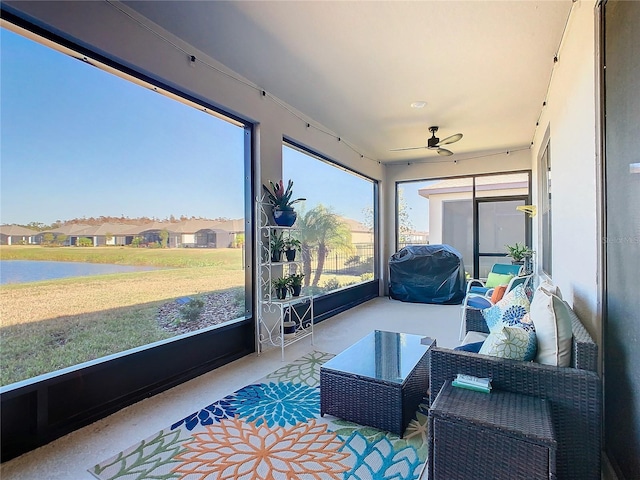 sunroom / solarium featuring ceiling fan