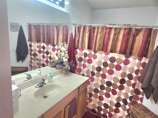 bathroom featuring a textured ceiling and vanity
