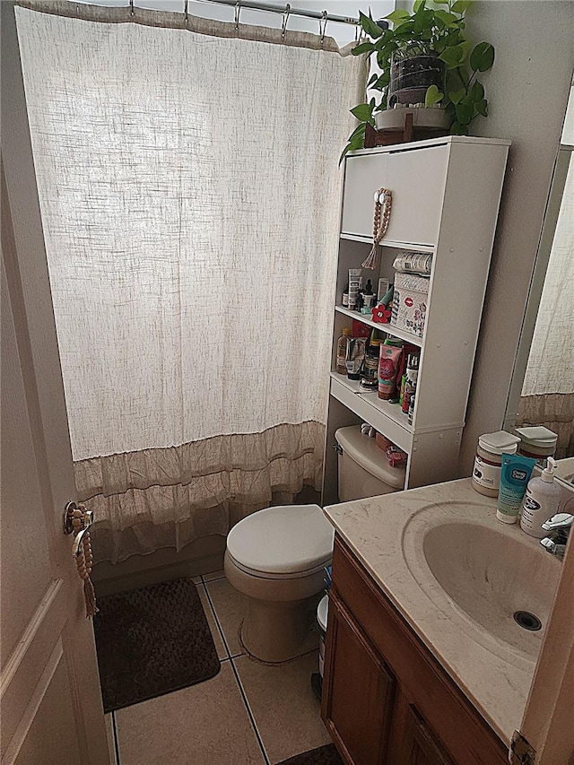 full bathroom featuring toilet, tile patterned flooring, shower / bathtub combination with curtain, and vanity