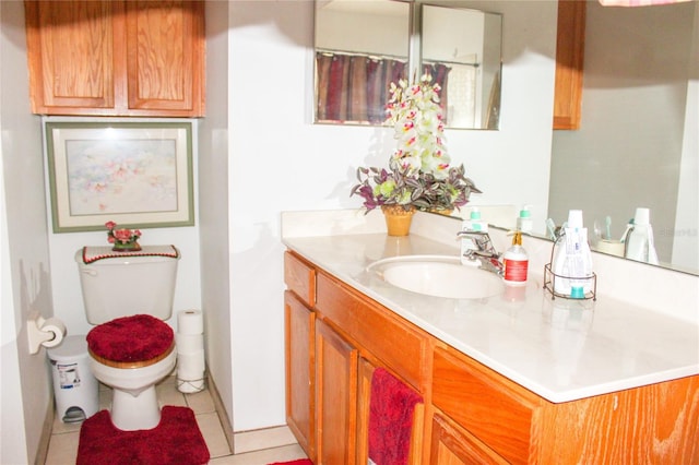 1053 Hemingway Dr, Deltona, FL 32725 - full bath featuring toilet, vanity, tile patterned flooring, and baseboards