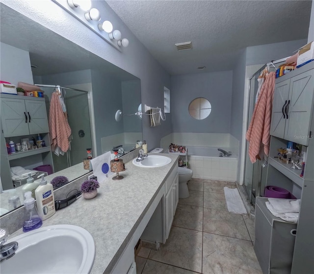 full bathroom featuring vanity, plus walk in shower, tile patterned floors, toilet, and a textured ceiling