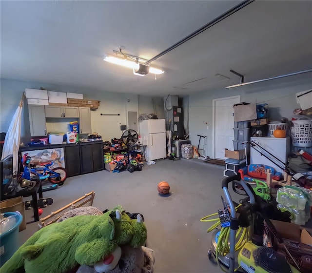 garage with heating unit, a garage door opener, and white refrigerator