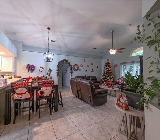 dining area featuring light tile patterned floors and ceiling fan with notable chandelier