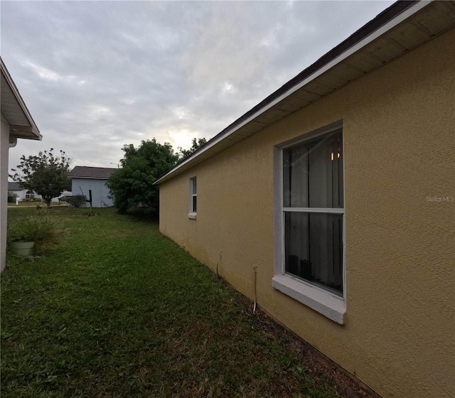 view of property exterior with a yard