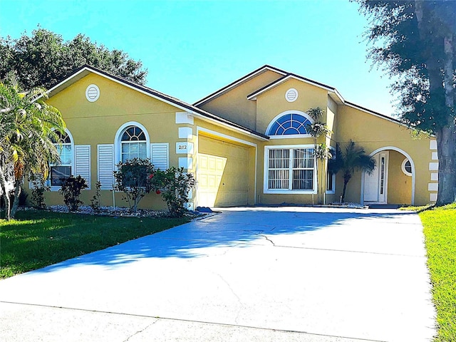 view of front of home featuring a garage and a front yard