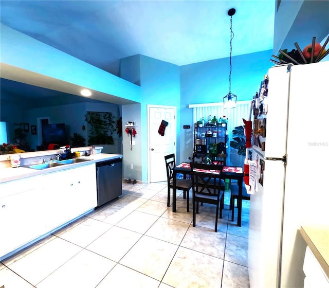 kitchen with sink, light tile patterned flooring, dishwasher, decorative light fixtures, and white refrigerator