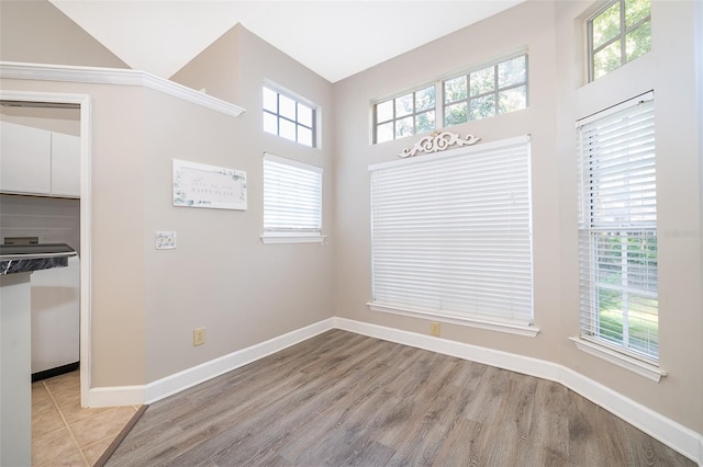 interior space with light hardwood / wood-style floors and a towering ceiling