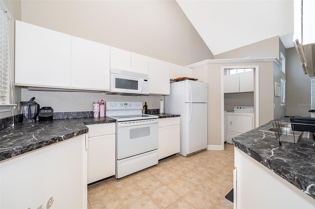 kitchen featuring white appliances, high vaulted ceiling, dark stone countertops, white cabinets, and washing machine and dryer