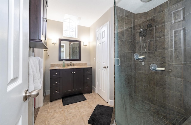 bathroom featuring tile patterned flooring, vanity, and walk in shower