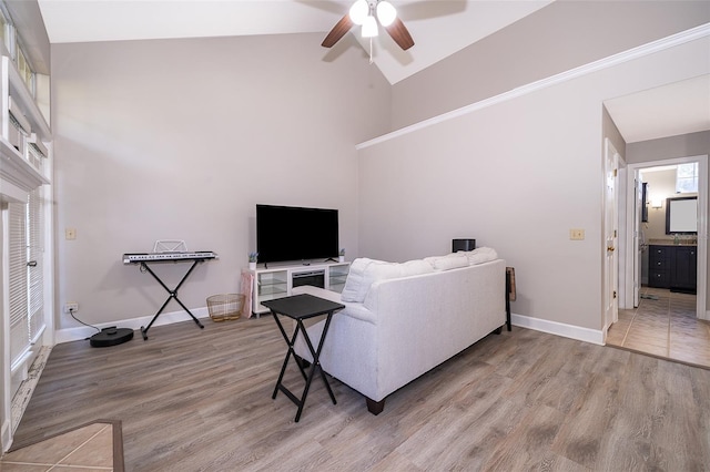 living room featuring light wood-type flooring, high vaulted ceiling, and ceiling fan