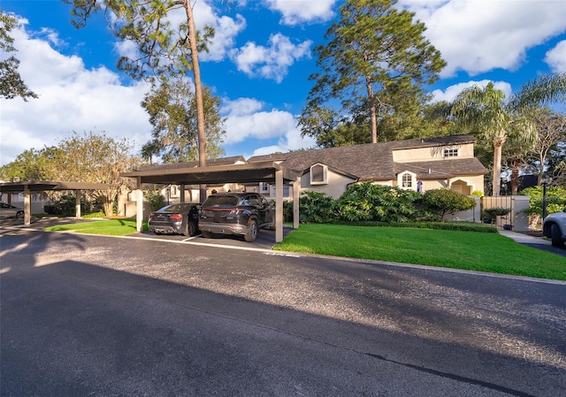 view of front of house with a front yard and a carport