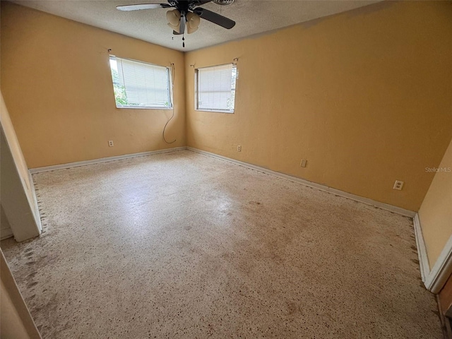 spare room with a textured ceiling and ceiling fan