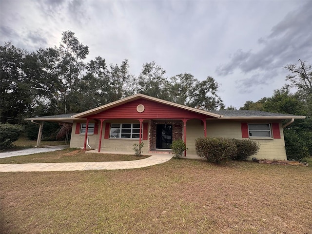 ranch-style home featuring a front yard and a carport