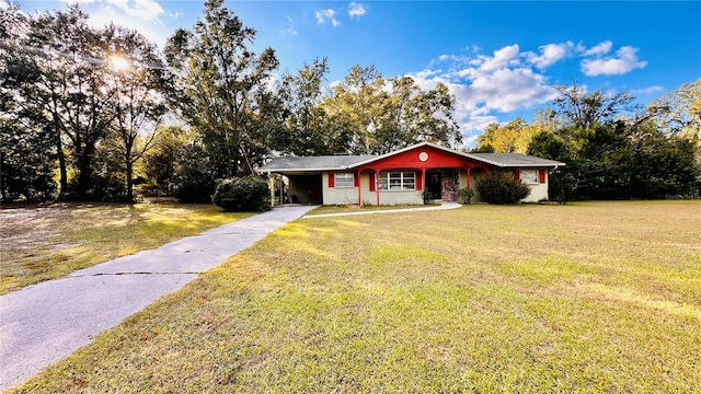 ranch-style house featuring a front yard and a carport