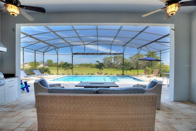 view of pool featuring glass enclosure and a patio