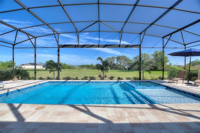 view of pool featuring glass enclosure and a patio area