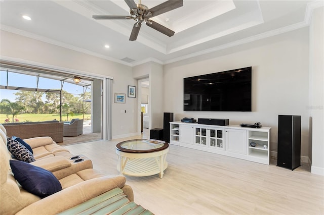 living room with light wood-type flooring, ceiling fan, and ornamental molding