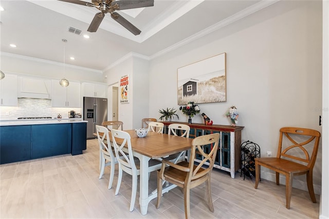 dining space with crown molding and ceiling fan