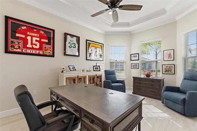 office space featuring ceiling fan, a raised ceiling, crown molding, and a wealth of natural light