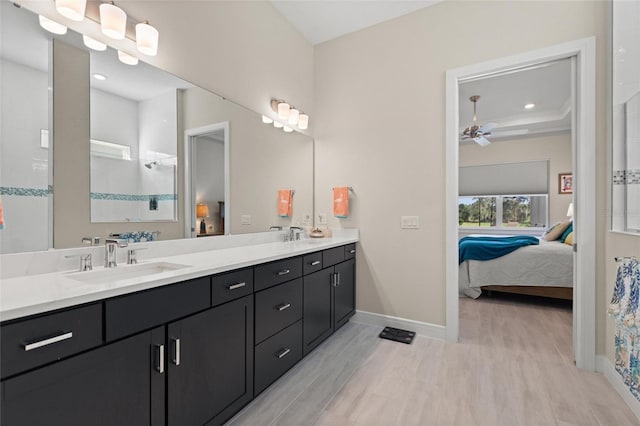 bathroom featuring hardwood / wood-style floors, ceiling fan, a shower, and vanity