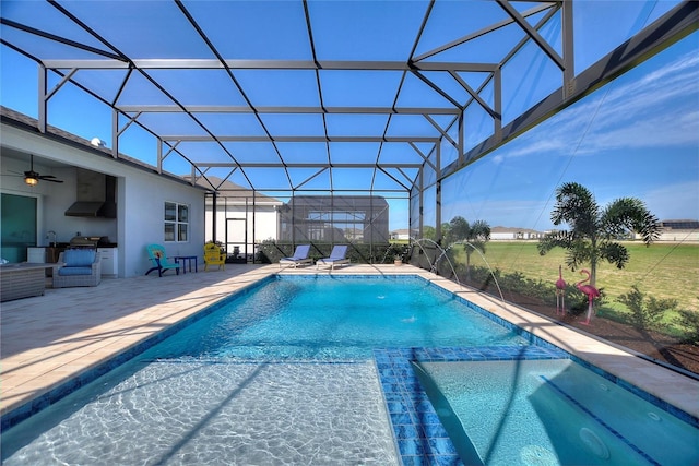 view of pool with pool water feature, a patio, and glass enclosure