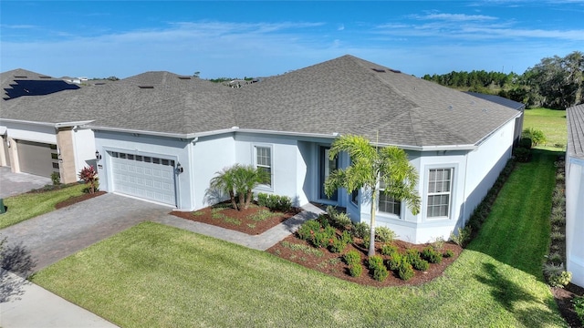 ranch-style house featuring a front lawn and a garage