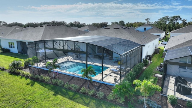 rear view of property with a lawn, a lanai, a patio, and central AC