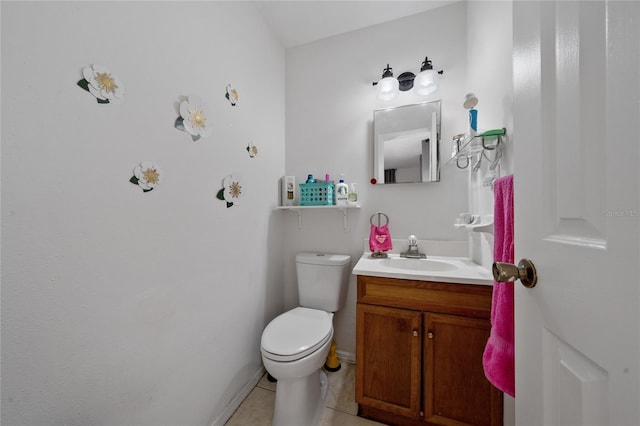 bathroom featuring tile patterned floors, vanity, and toilet