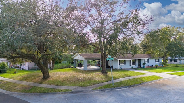 ranch-style house with a front yard and a carport