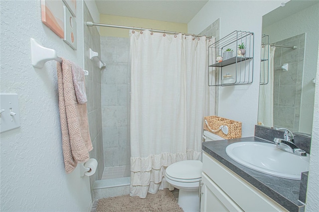 bathroom with vanity, curtained shower, and toilet