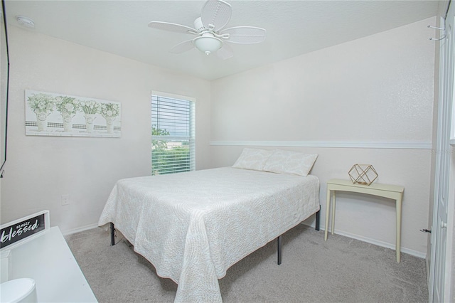 bedroom with light carpet and ceiling fan