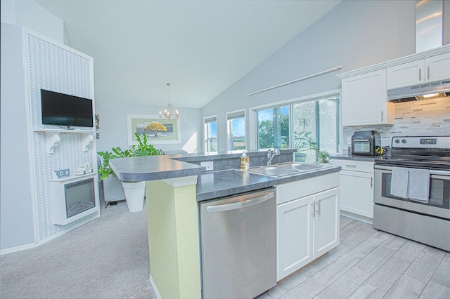 kitchen with appliances with stainless steel finishes, an inviting chandelier, white cabinetry, and sink