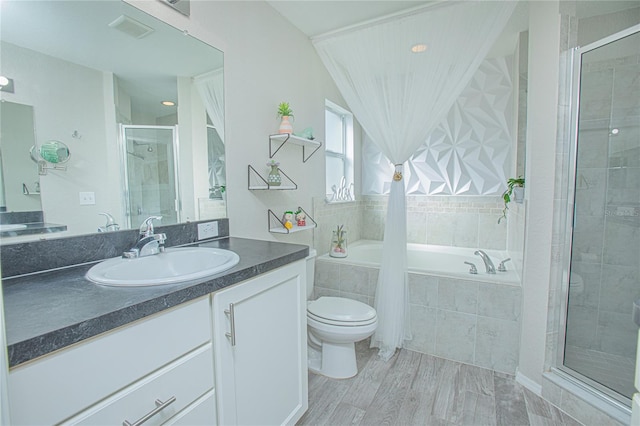 full bathroom with separate shower and tub, toilet, vanity, and hardwood / wood-style flooring