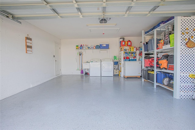 garage featuring washer and dryer and a garage door opener