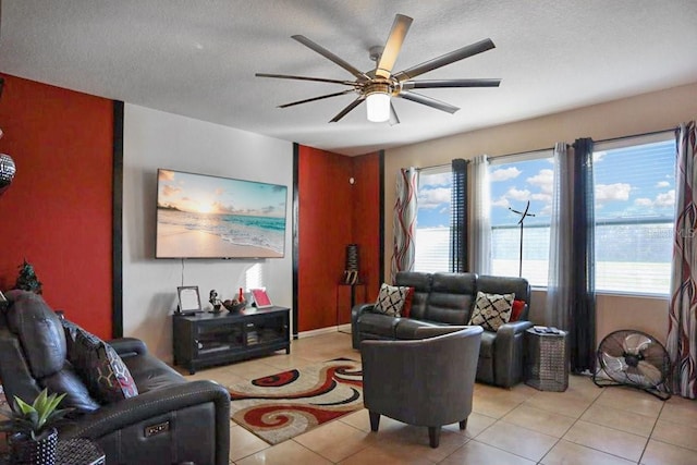 living room with light tile patterned floors, a textured ceiling, and ceiling fan