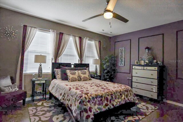 bedroom featuring ceiling fan and a textured ceiling